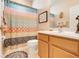 Bathroom featuring a colorful shower curtain, neutral walls, and a patterned bath mat at 5263 Beach River Road, Windermere, FL 34786