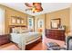 Comfortable bedroom featuring stylish furnishings, wood floors, and an airy, sunlit ambiance at 5263 Beach River Road, Windermere, FL 34786