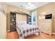 Cozy bedroom boasts a custom murphy bed and cheerful decor that maximizes space at 5263 Beach River Road, Windermere, FL 34786