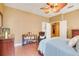 This bedroom features warm wall colors, wood floors, neutral decor, and a cozy reading nook at 5263 Beach River Road, Windermere, FL 34786