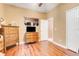Comfortable bedroom featuring warm wall colors, wood floors, and two dressers at 5263 Beach River Road, Windermere, FL 34786