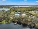 Aerial view of community featuring a dock, pool, and tennis courts near a lake at 5263 Beach River Road, Windermere, FL 34786