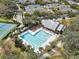 Aerial shot of the community pool and lounging area surrounded by lush landscaping and mature trees at 5263 Beach River Road, Windermere, FL 34786