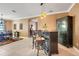 Charming dining area features stylish bar with seating and an elegant black china cabinet at 5263 Beach River Road, Windermere, FL 34786