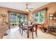 Dining room featuring a large table, windows, and sliding glass door to the backyard at 5263 Beach River Road, Windermere, FL 34786