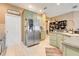 Spacious kitchen featuring stainless steel refrigerator and well-lit countertops at 5263 Beach River Road, Windermere, FL 34786