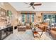 Comfortable living room with a ceiling fan, large windows, and a cozy sectional sofa at 5263 Beach River Road, Windermere, FL 34786