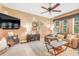 Cozy living room featuring a flat screen TV, ceiling fan, and comfortable sectional sofa at 5263 Beach River Road, Windermere, FL 34786