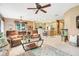 Inviting living room with ceiling fans, comfortable seating, and view into the kitchen at 5263 Beach River Road, Windermere, FL 34786