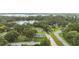Aerial view of lakeside home with mature trees, and a picturesque setting at 5521 Makoma Dr, Orlando, FL 32839