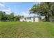 Spacious backyard with lush grass and mature trees perfect for outdoor enjoyment at 5521 Makoma Dr, Orlando, FL 32839
