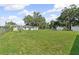 Expansive backyard with a large grassy area and mature trees, perfect for recreation at 5521 Makoma Dr, Orlando, FL 32839