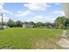 Large backyard with a well-maintained lawn, a detached garage, and mature trees at 5521 Makoma Dr, Orlando, FL 32839