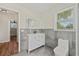 Modern bathroom with stylish vanity, mirror, and tiled walls at 5521 Makoma Dr, Orlando, FL 32839