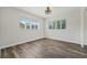 This bedroom has wood-look floors and lots of light from two windows at 5521 Makoma Dr, Orlando, FL 32839