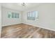 Bright bedroom with wood-look floors and two big windows at 5521 Makoma Dr, Orlando, FL 32839