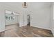 Bright bedroom with wood-look flooring, large mirror closet, and updated ceiling fan at 5521 Makoma Dr, Orlando, FL 32839