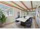 Bright dining room with exposed beam ceiling, marble table, and big windows at 5521 Makoma Dr, Orlando, FL 32839