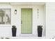 Close-up showcasing the home's front door, planters, and address with a fresh, inviting entrance at 5521 Makoma Dr, Orlando, FL 32839