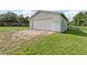 Detached one car garage with brick parking pad, offering ample storage and parking at 5521 Makoma Dr, Orlando, FL 32839