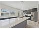 Modern kitchen featuring custom cabinets, stainless steel appliances, and a large center island at 5521 Makoma Dr, Orlando, FL 32839