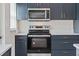 Modern kitchen with stainless steel appliances, stylish cabinets, and contemporary finishes at 5521 Makoma Dr, Orlando, FL 32839