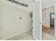 Laundry room features tile flooring, modern shelving, and access to other rooms at 5521 Makoma Dr, Orlando, FL 32839