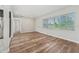 Spacious area with hardwood floors, natural light, and neutral decor, offering a versatile living space at 5521 Makoma Dr, Orlando, FL 32839