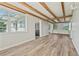 Open living room with wood flooring, lots of light, and white wooden ceilings with exposed beams at 5521 Makoma Dr, Orlando, FL 32839