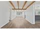 Spacious living room with light wood floors and white walls with exposed beam ceilings at 5521 Makoma Dr, Orlando, FL 32839