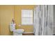 Bright bathroom featuring a shower/tub combo with a window for natural light at 5891 Sir Henry Rd, Orlando, FL 32808