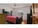 Bedroom featuring a black bed frame with a red patterned comforter at 5891 Sir Henry Rd, Orlando, FL 32808