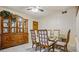 Traditional dining room featuring a glass-top table, upholstered chairs, and a large china cabinet at 5891 Sir Henry Rd, Orlando, FL 32808