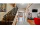 Foyer featuring a staircase, hardwood and tile floors at 5891 Sir Henry Rd, Orlando, FL 32808