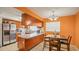 Cozy kitchen with granite countertops and stainless steel appliances, and a dining area at 5891 Sir Henry Rd, Orlando, FL 32808
