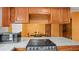Close-up of granite countertops and appliances with a microwave and a stovetop at 5891 Sir Henry Rd, Orlando, FL 32808