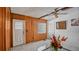 A cozy living room featuring wood paneling, a ceiling fan, and patterned floors at 5891 Sir Henry Rd, Orlando, FL 32808