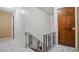 A staircase featuring dark wood steps and decorative iron railing at 5891 Sir Henry Rd, Orlando, FL 32808
