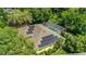 Aerial view of house featuring a screened-in pool and solar panels on the roof for energy efficiency at 6092 Sabal Hammock Cir, Port Orange, FL 32128