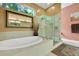 Bathroom with a soaking tub, glass-enclosed shower, and elegant fixtures for a spa-like experience at 6092 Sabal Hammock Cir, Port Orange, FL 32128