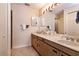 Well lit bathroom with a double sink, spacious countertop and unique woven style cabinets at 6226 Wynfield Court, Orlando, FL 32819