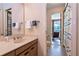 Neutral toned bathroom with a sink, mirror and bath towels next to the toilet and screened in patio at 6226 Wynfield Court, Orlando, FL 32819