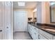 Hallway bathroom showcases white cabinets, granite countertops, double sinks, and plenty of storage at 6226 Wynfield Court, Orlando, FL 32819