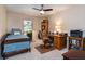 Bedroom features a bed, desk, ceiling fan, and plenty of natural light from the window at 6226 Wynfield Court, Orlando, FL 32819