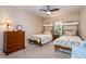 Charming bedroom with twin beds, floral comforters, and a ceiling fan at 6226 Wynfield Court, Orlando, FL 32819