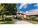Attractive home featuring stone accents, a well-manicured lawn, and a driveway at 6226 Wynfield Court, Orlando, FL 32819