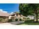 Well-maintained home featuring a stone facade, manicured landscaping, and a long driveway at 6226 Wynfield Court, Orlando, FL 32819