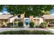 Inviting front entrance with a modern blue door, complemented by manicured landscaping and stone accents at 6226 Wynfield Court, Orlando, FL 32819
