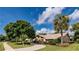 Charming home with lush landscaping, mature trees, and a well-maintained lawn at 6226 Wynfield Court, Orlando, FL 32819