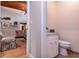 Powder room includes a decorative mirror, vanity, toilet, and modern fixtures at 6226 Wynfield Court, Orlando, FL 32819